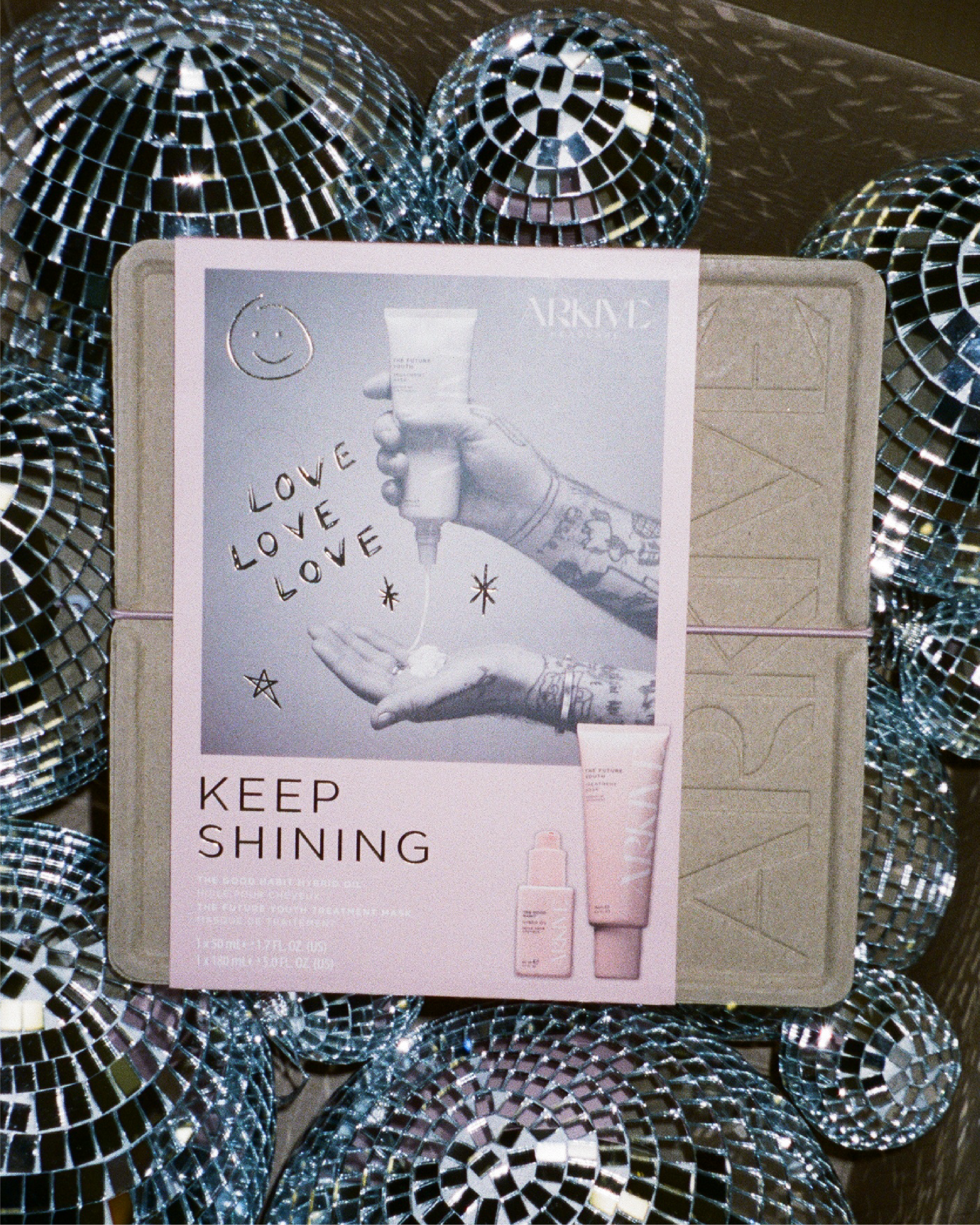 Arkive Keep Shining christmas gift set against a disco ball background