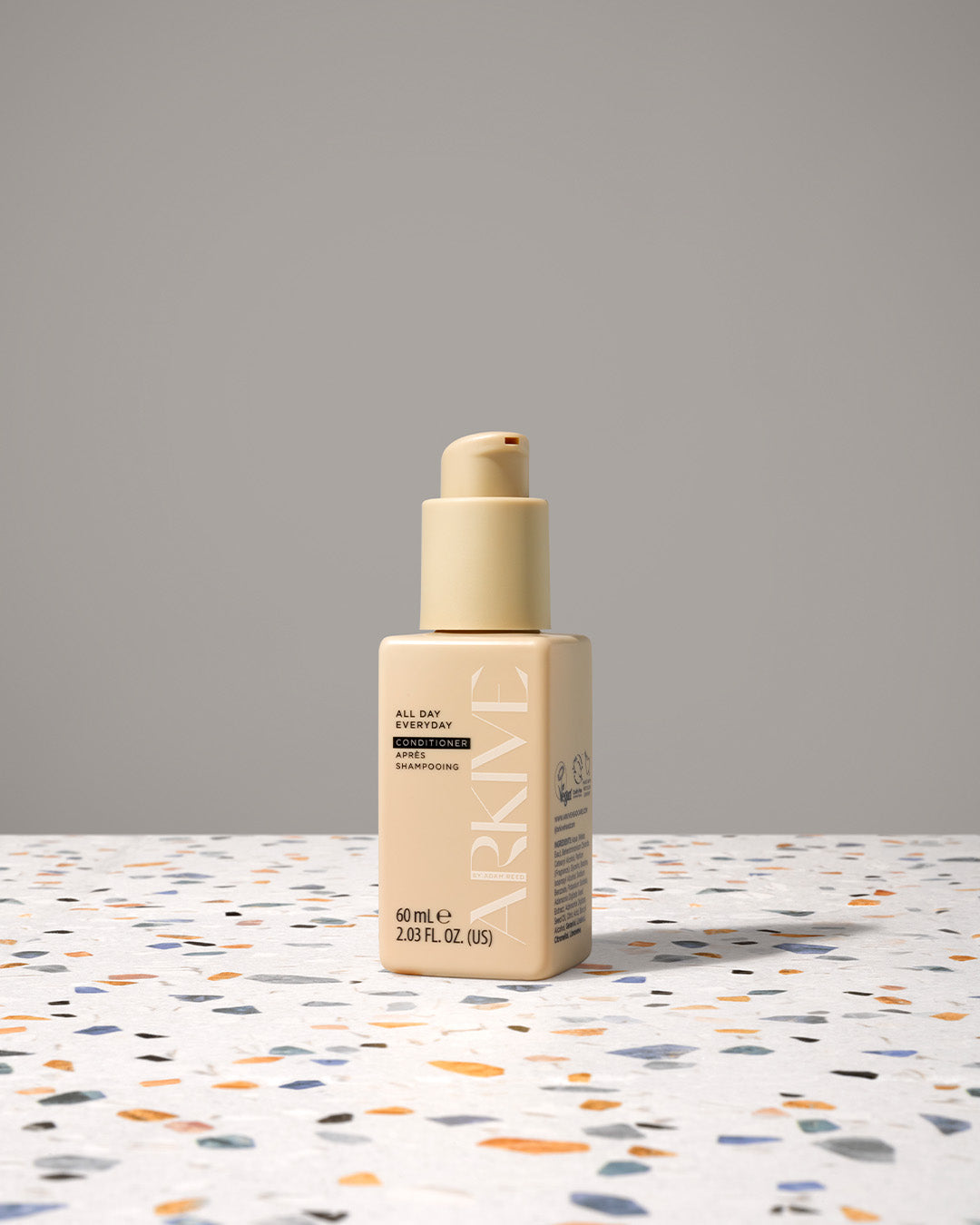 Miniature bottle of Arkive's all day everyday conditioner on a table