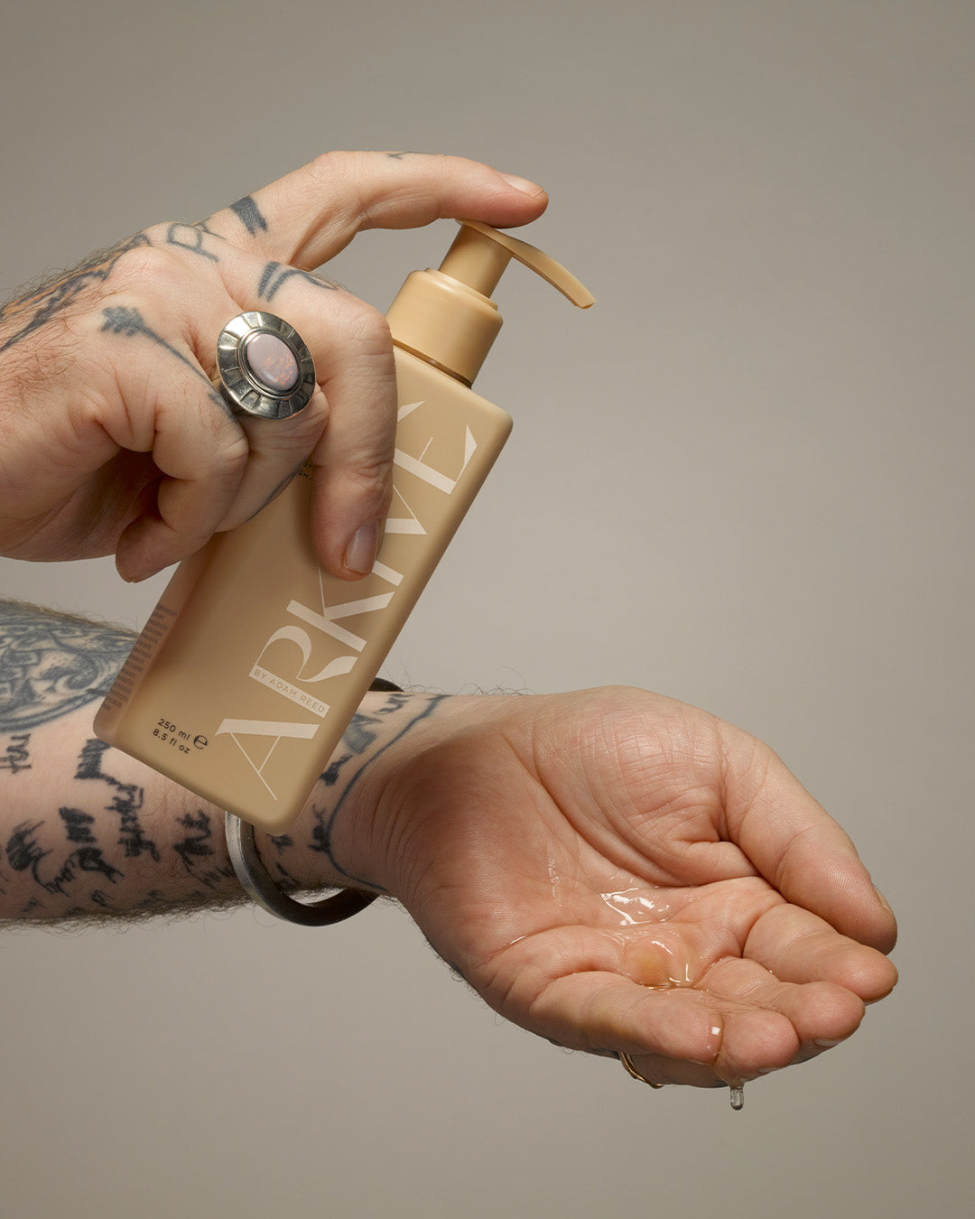 A bottle of Arkive's all day everyday shampoo poured into the hand