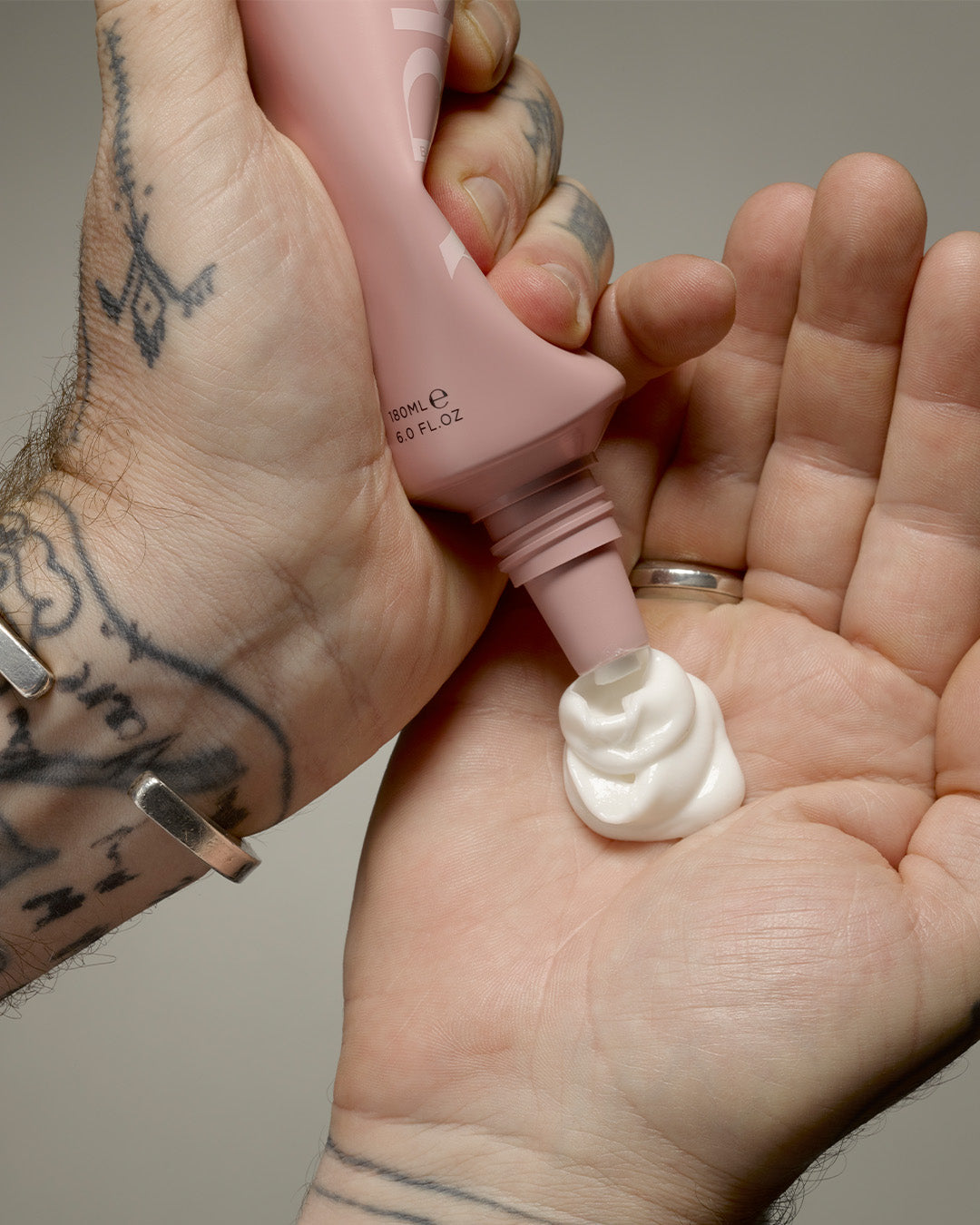 Arkive's scalp scrub being poured onto a the hands