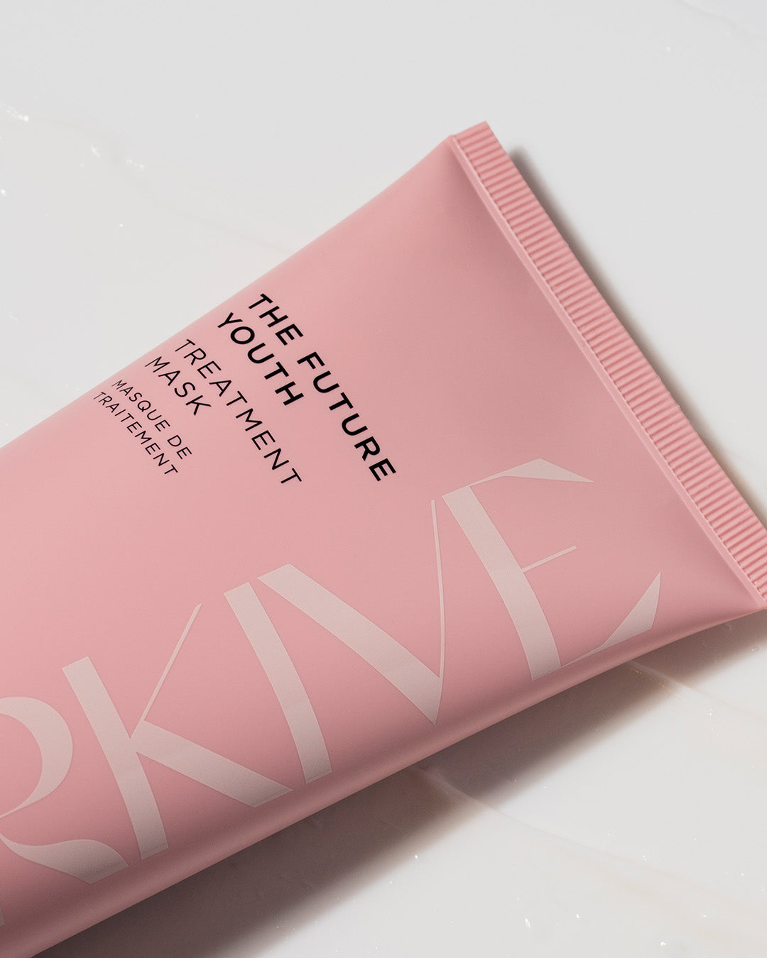A close up shot of a bottle of Arkive's The Future Youth hair treatment mask