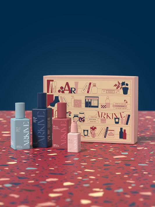 Arkive's Strong on Styling Set, featuring The Good Habit Hybrid Oil, The New Form Blow Dry Hairspray, The Prologue Primer and The Mastery Hairspray, laid out on a patterned table